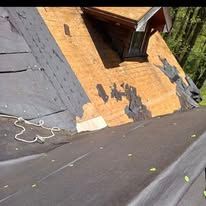 A house with a roof that is being repaired.