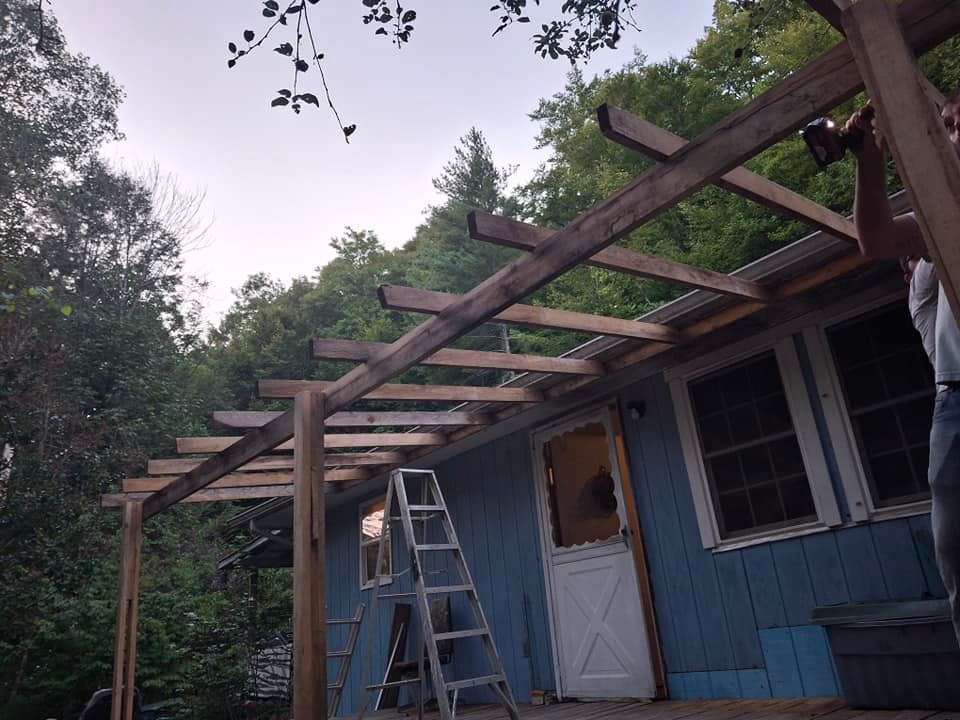A blue house with a ladder in front of it