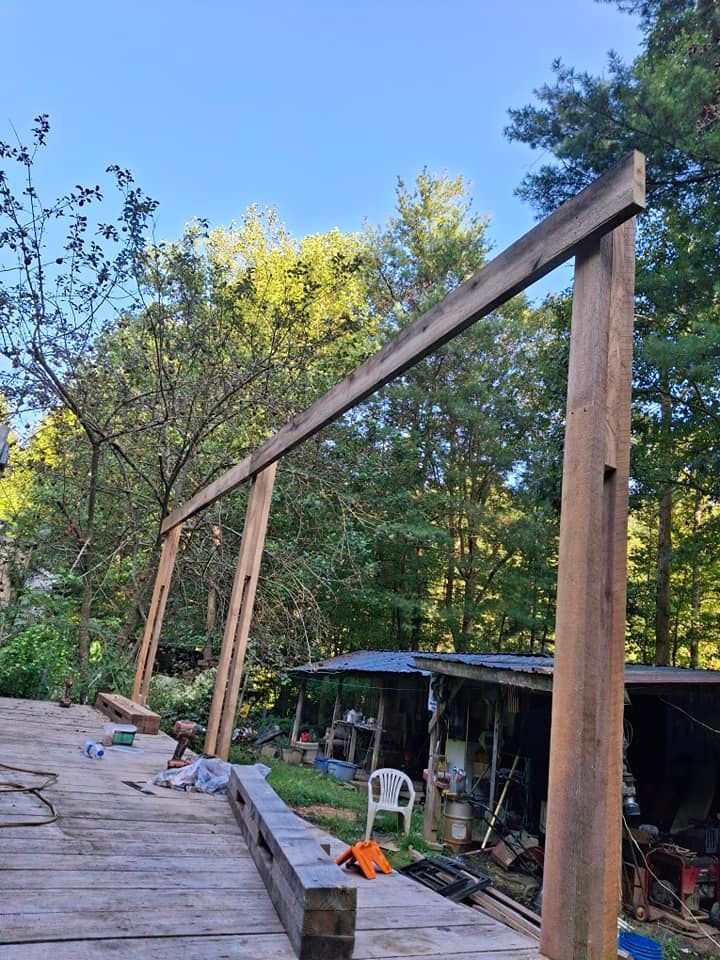 A wooden structure is being built in the woods.