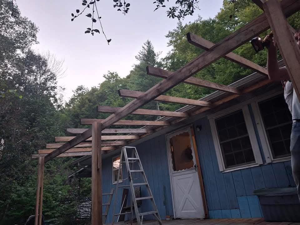 A blue house with a ladder in front of it