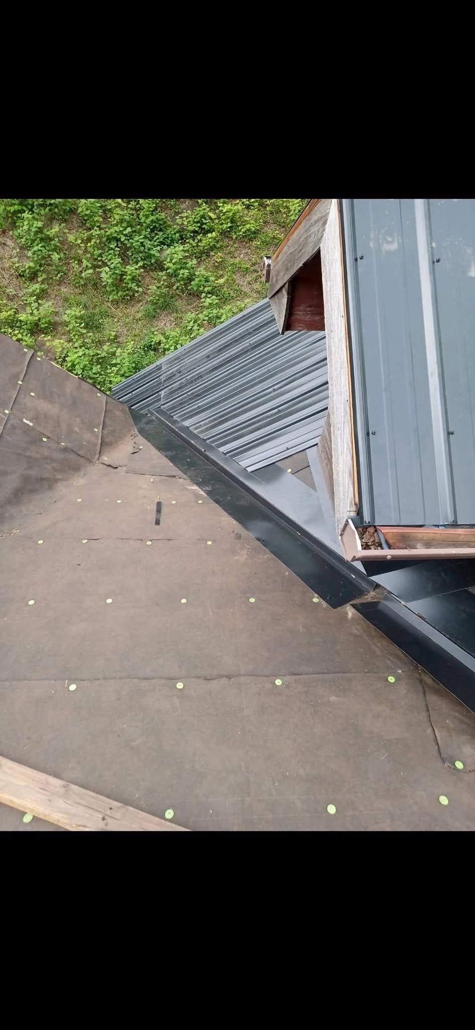A close up of a roof with a gutter on the side of it.