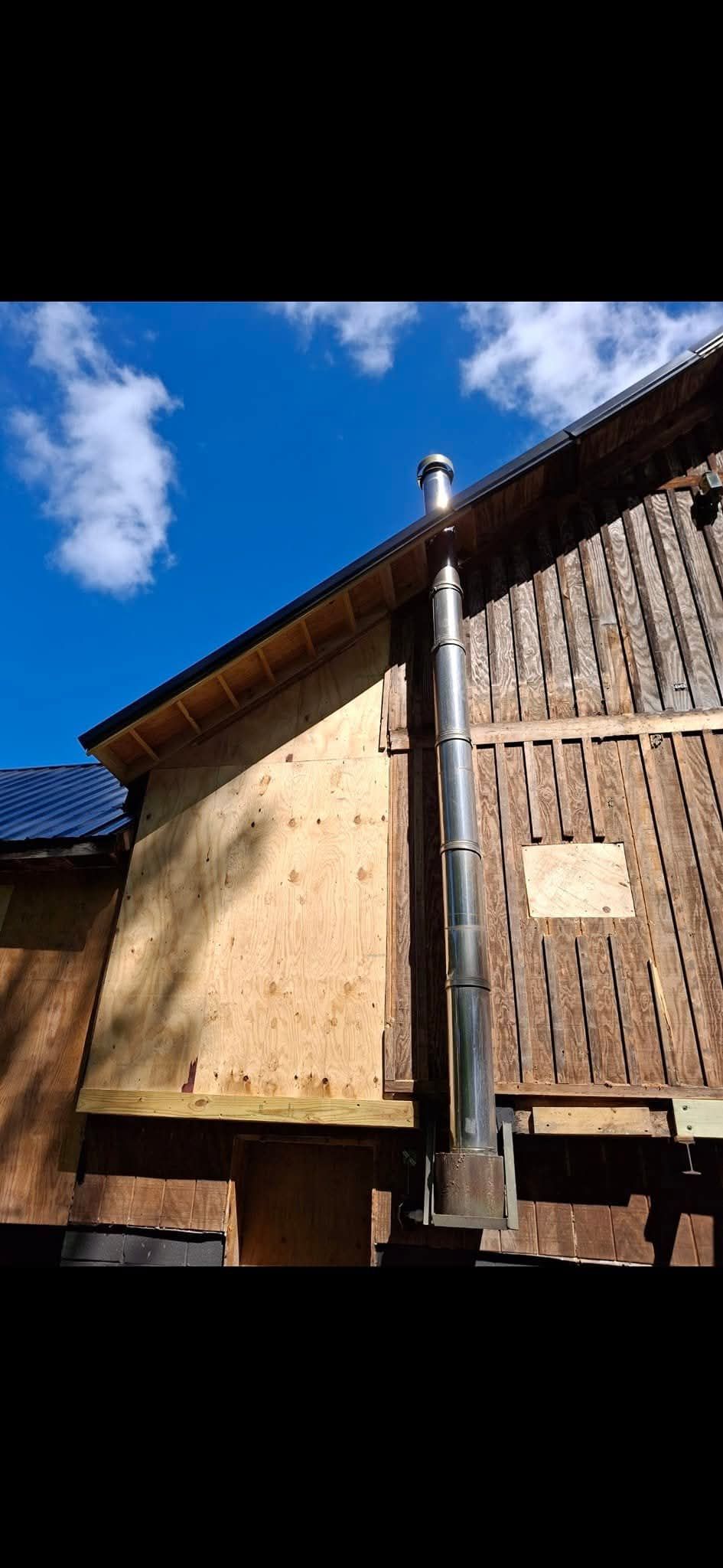 A house with a chimney on the side of it.