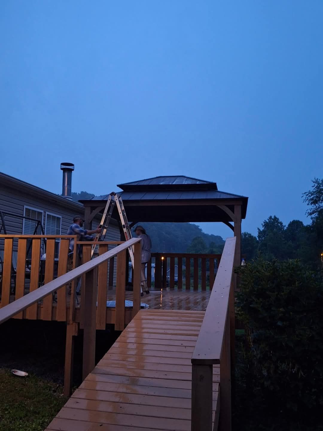 A wooden deck with a gazebo on top of it