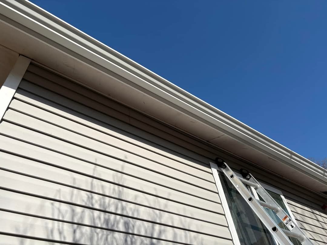 A ladder is hanging from the roof of a house