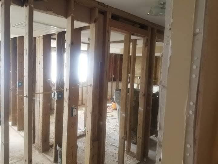 A room with a lot of wooden walls and a window.