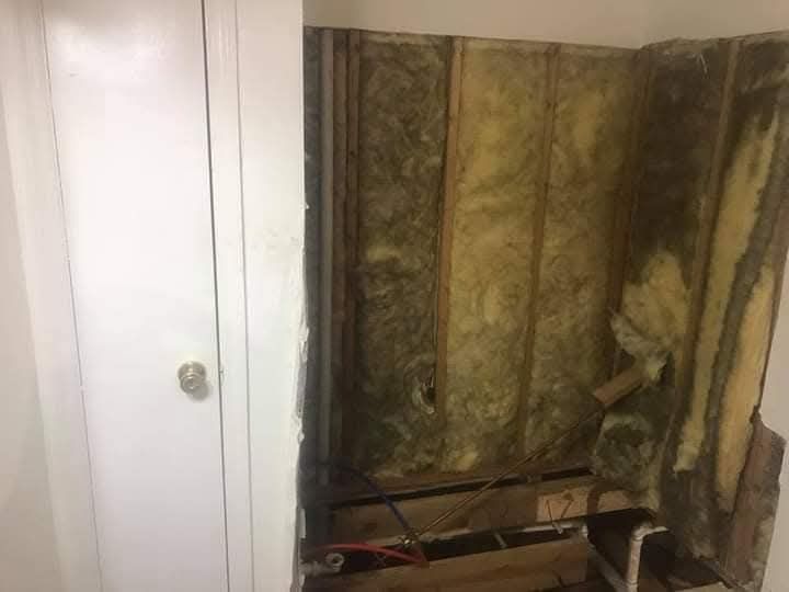 A room with a lot of insulation on the walls and a door.