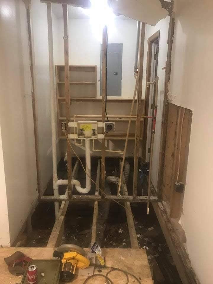 A bathroom under construction with a sink and a toilet.