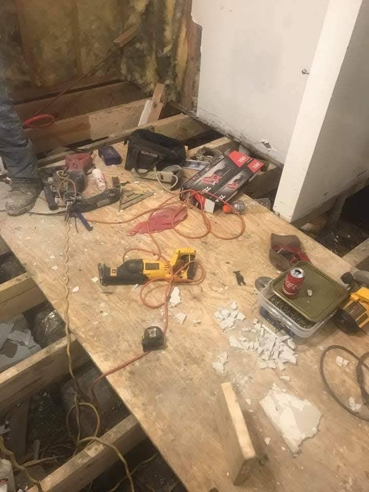 A wooden floor with a lot of tools on it.