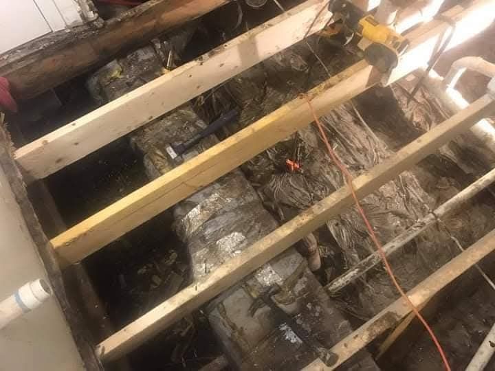 A person is working on the floor of a building.