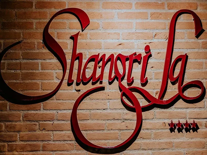 Placa vermelha cursiva com a inscrição