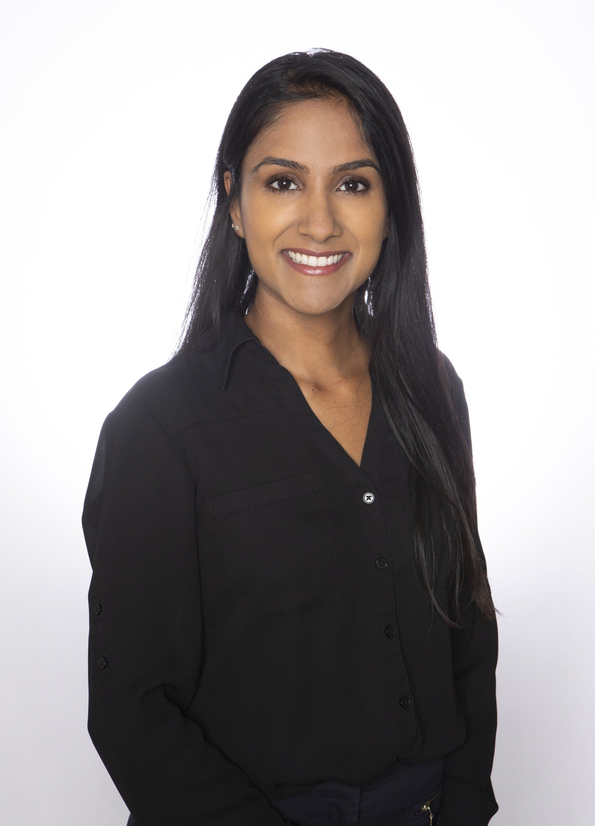 The woman is wearing a black shirt and smiling for the camera.