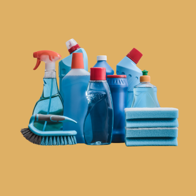 Assorted blue cleaning supplies including spray bottles, brushes, and sponges on a gold background.