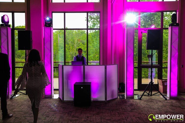 DJ Ethan Mazer behind party lighting and DJ booth.