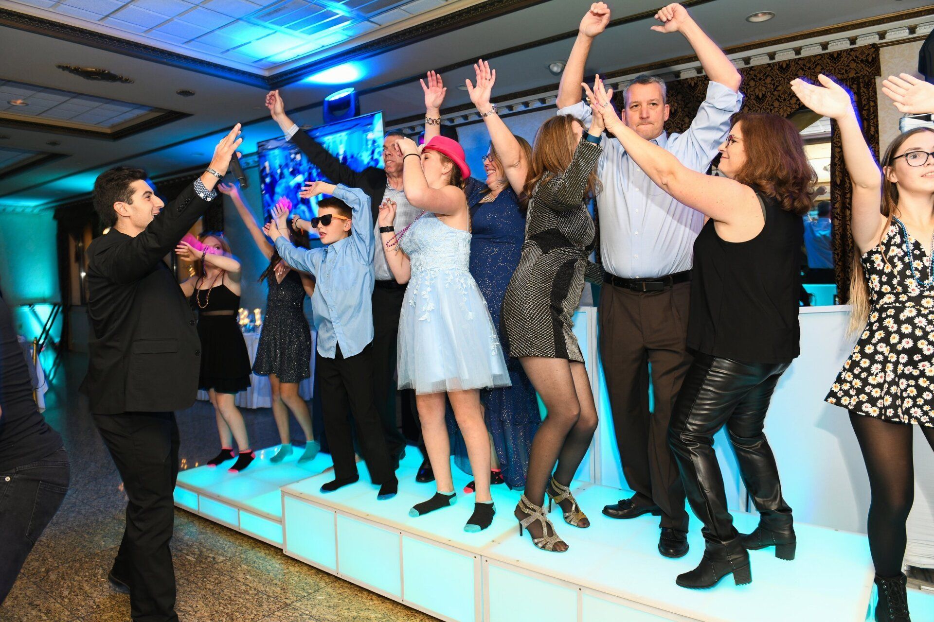 Bar Mitzvah guests dancing on LED DJ stage.