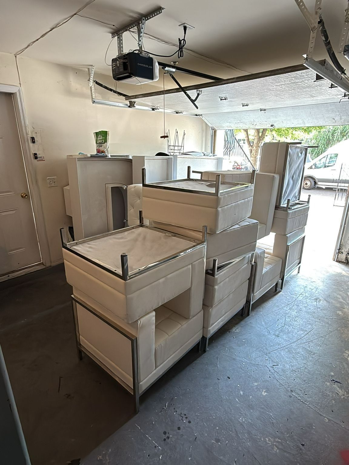 White cabinetry stacked in a garage, with a garage door opener visible above.