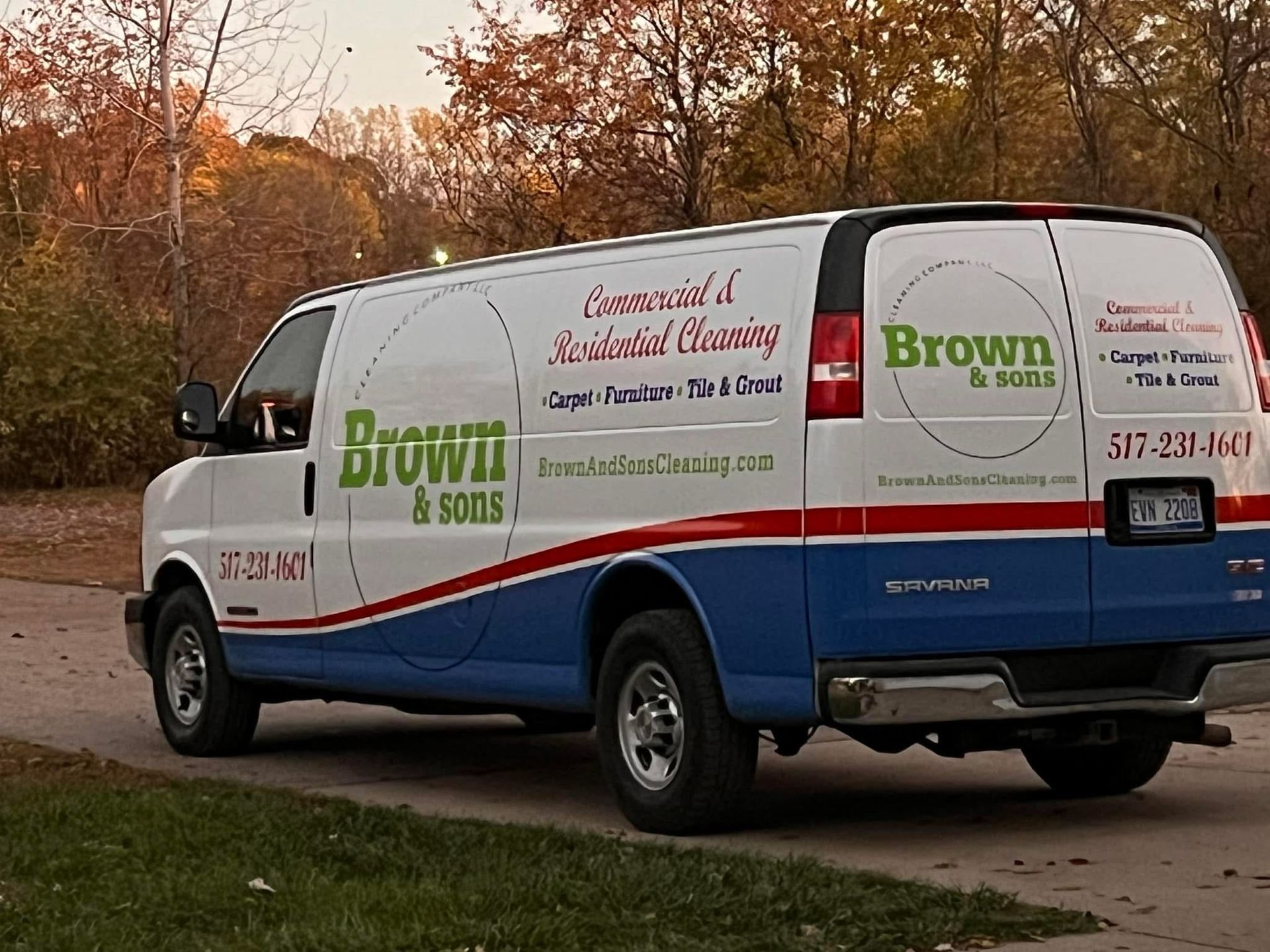 A brown and sons van is parked on the side of the road