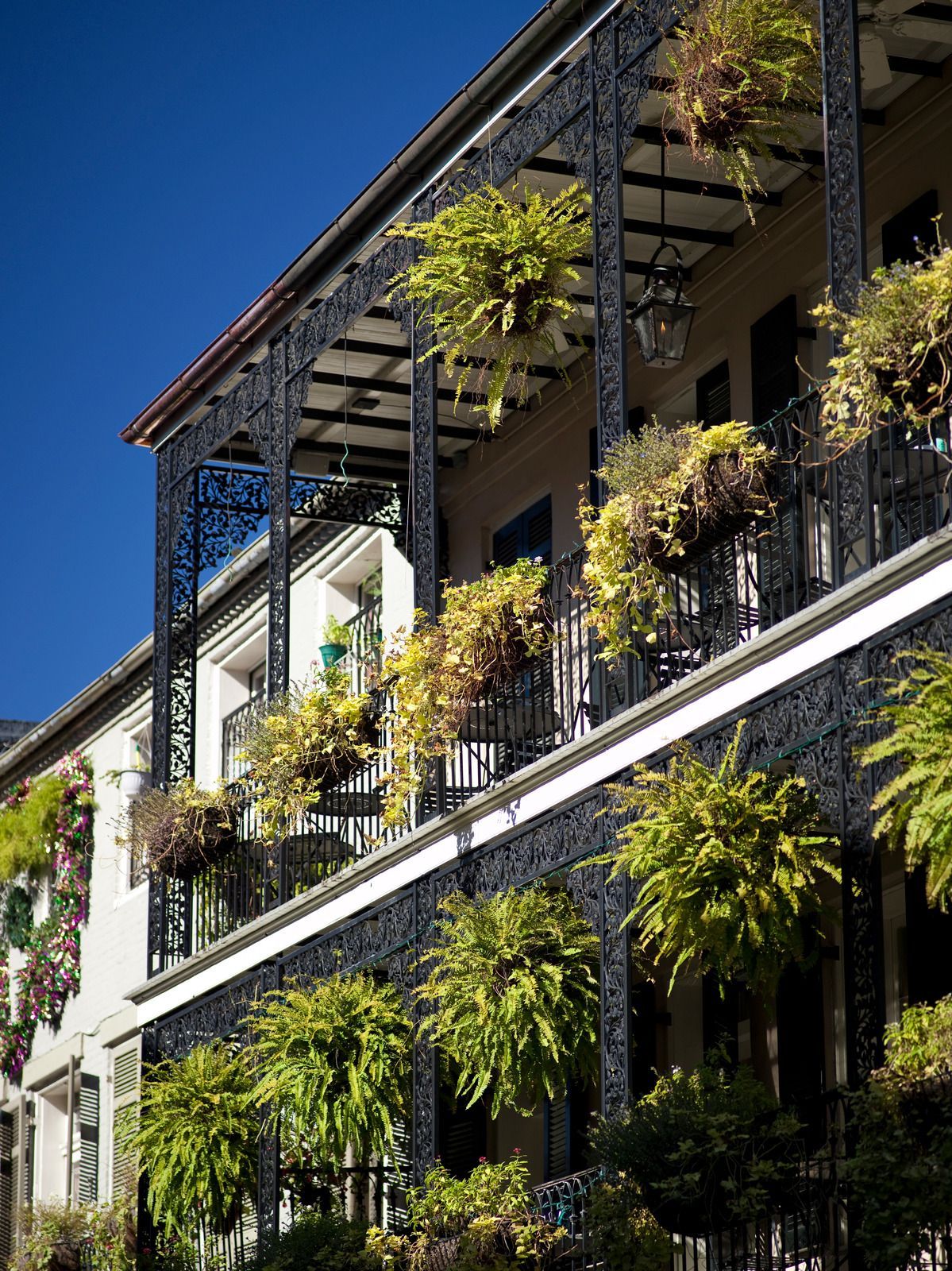 A white truck is parked in a parking lot next to a building.