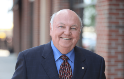 A man in a suit and tie is smiling for the camera.