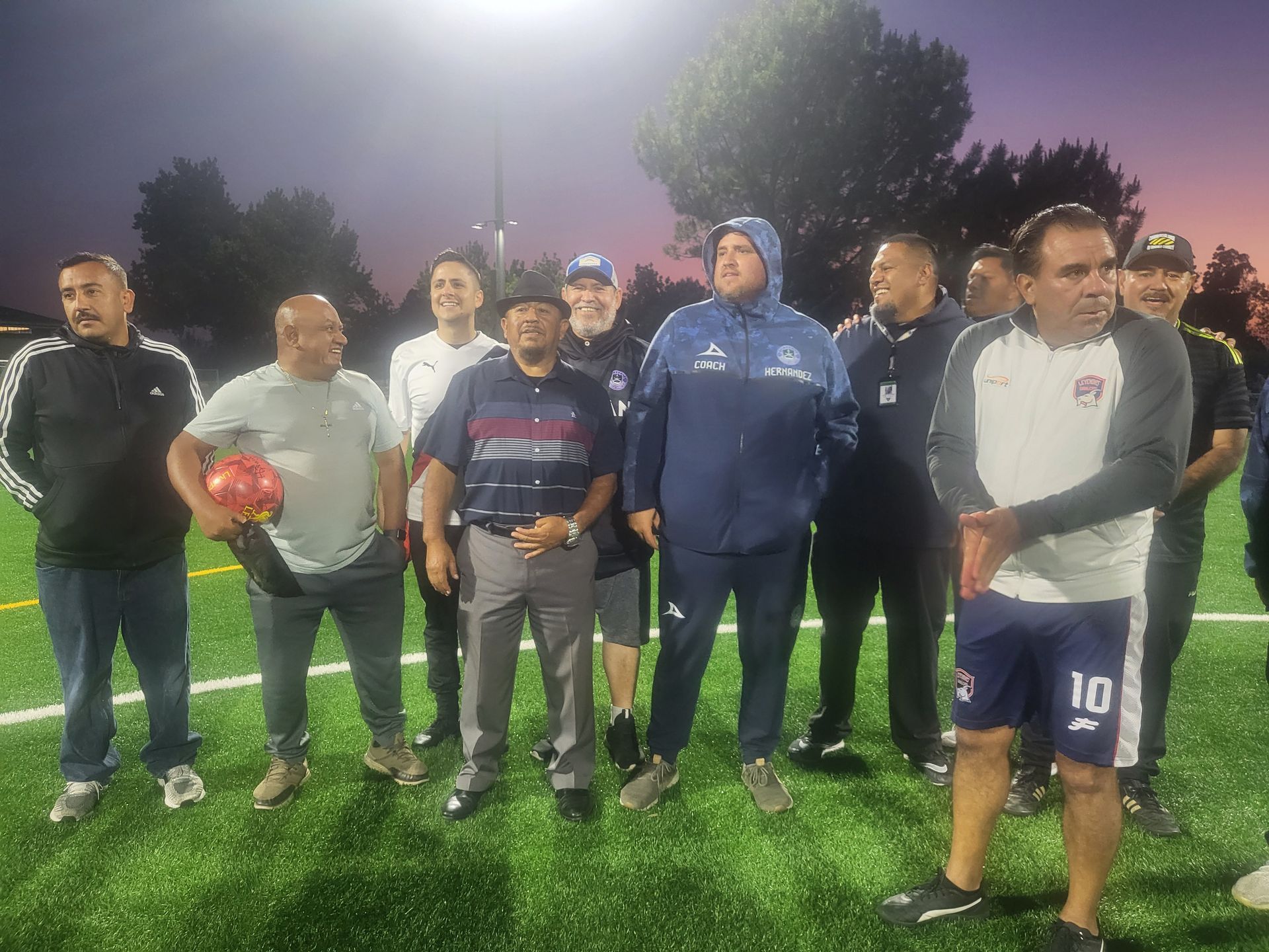 A group of men are standing on a soccer field  - Santa Ana, CA - Mesa Verde Youth Soccer League 
