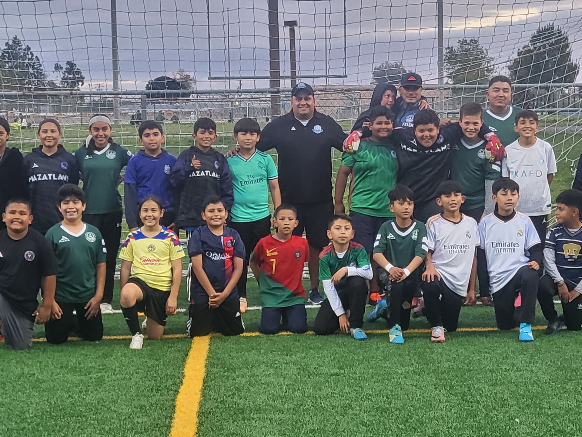 A group of young boys are posing for a picture on a soccer field - Santa Ana, CA - Mesa Verde Youth Soccer League 