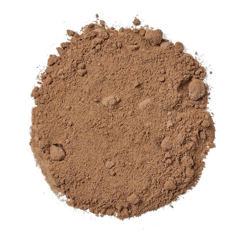 Pile of brown powder on a white background.