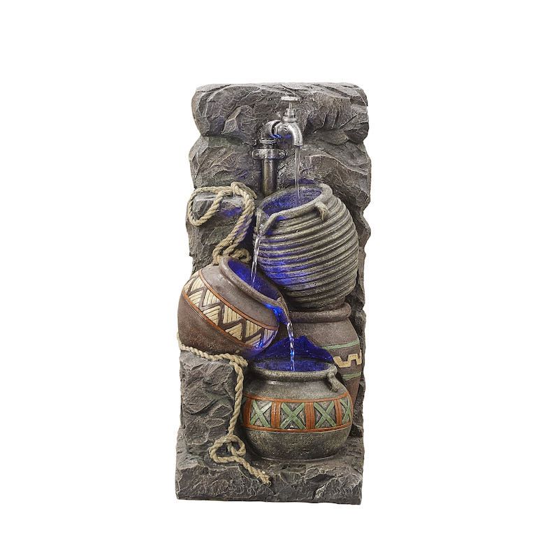Stone water fountain with jugs, water flowing, and rope detail.