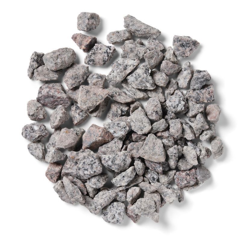 Pile of gray and pink granite gravel against a white background.