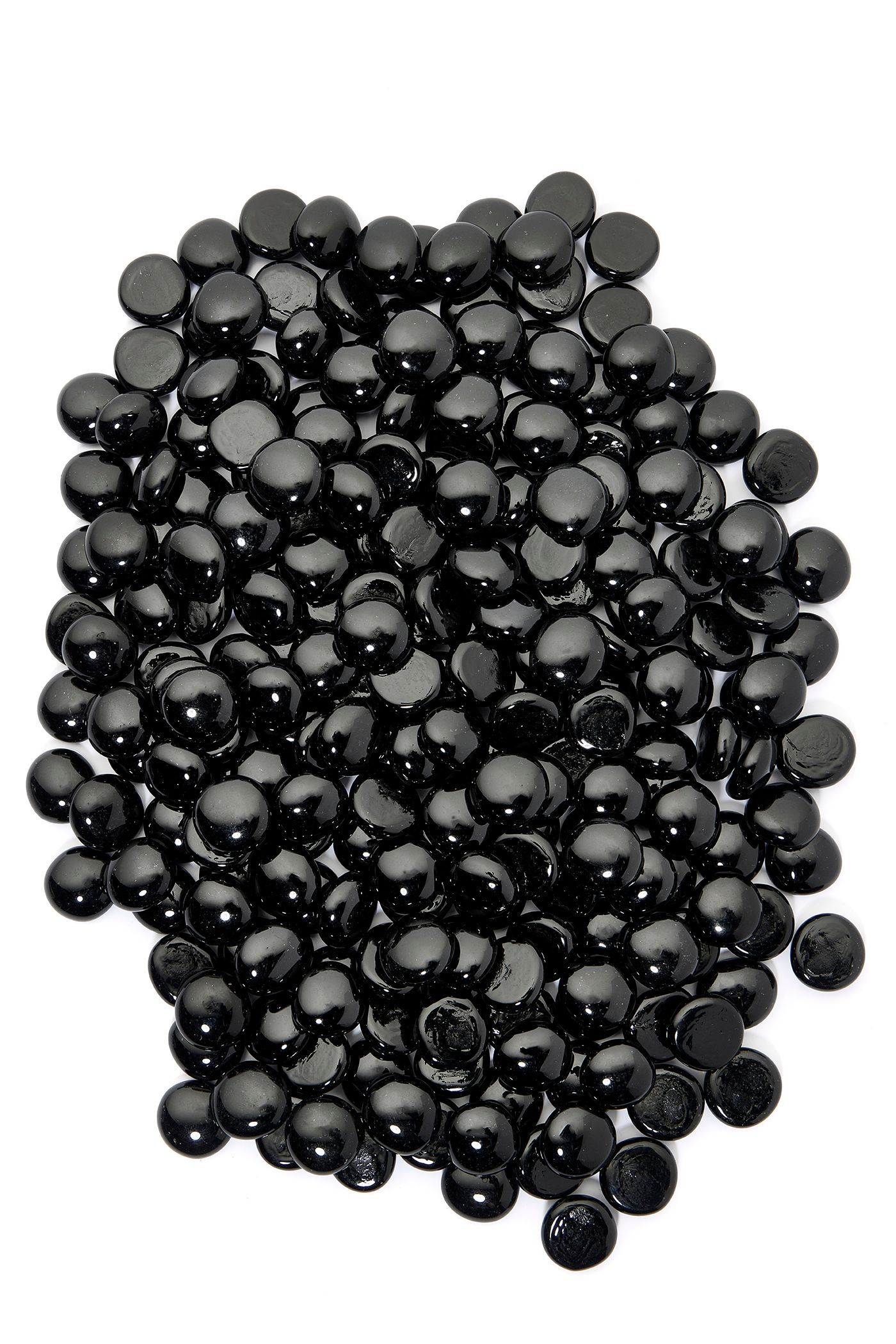 Pile of shiny, black, round beads on a white background.