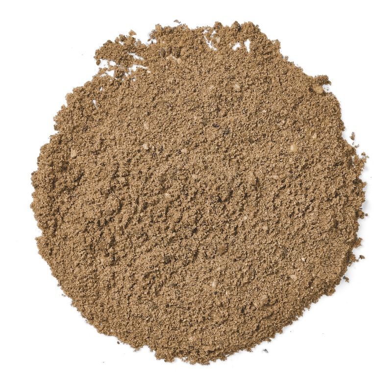 Pile of brown, finely ground powder, possibly spice, against a white background.