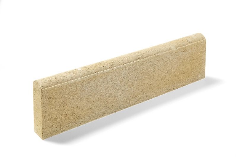 Tan rectangular concrete curb with rounded top.