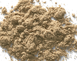 Pile of light brown sand on a white surface.