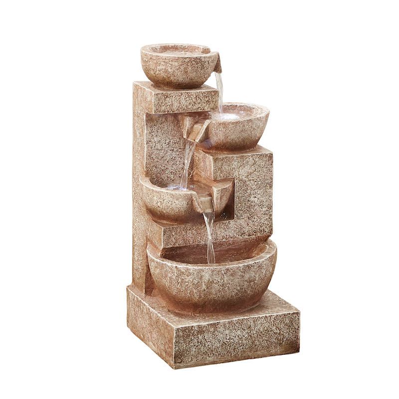 Stone-colored tiered fountain with water flowing from bowls, outdoor setting.