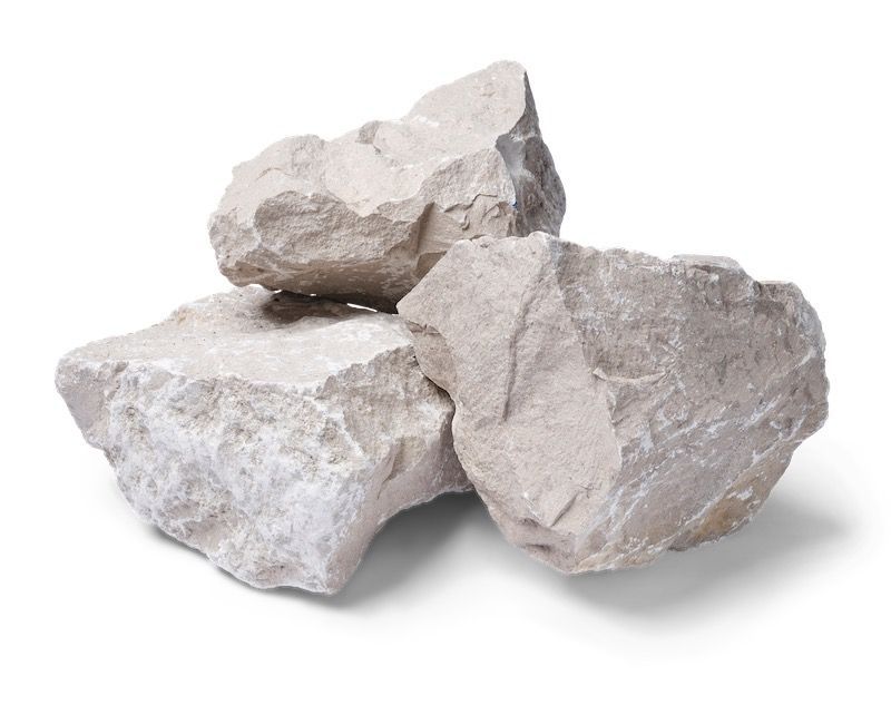 Three light-colored, irregularly shaped rocks stacked on top of each other.