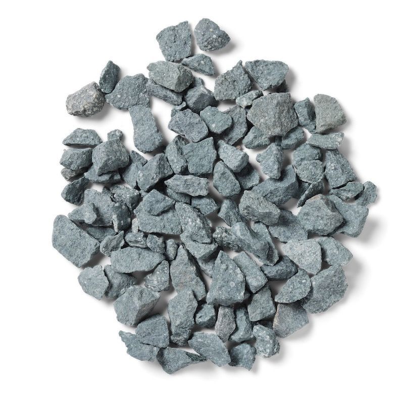 Pile of gray gravel rocks on a white surface.