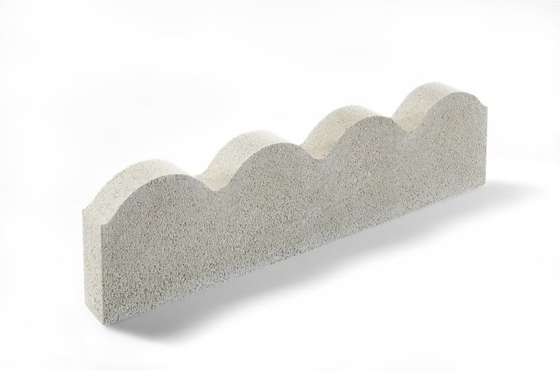 Gray scalloped concrete edging block on a white background.