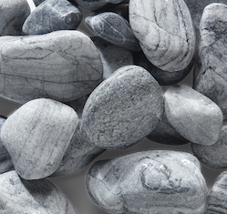 Pile of smooth, gray river rocks with swirling patterns and varying shapes.