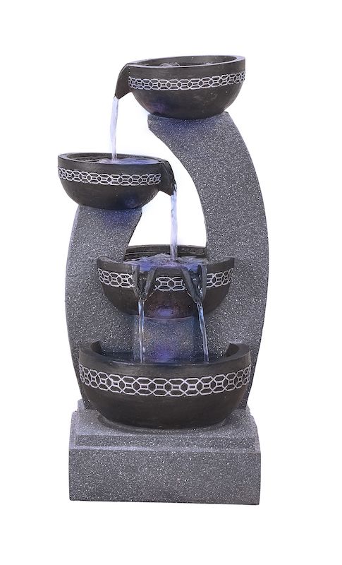 Indoor water fountain with four black bowls and gray base, water flowing down.