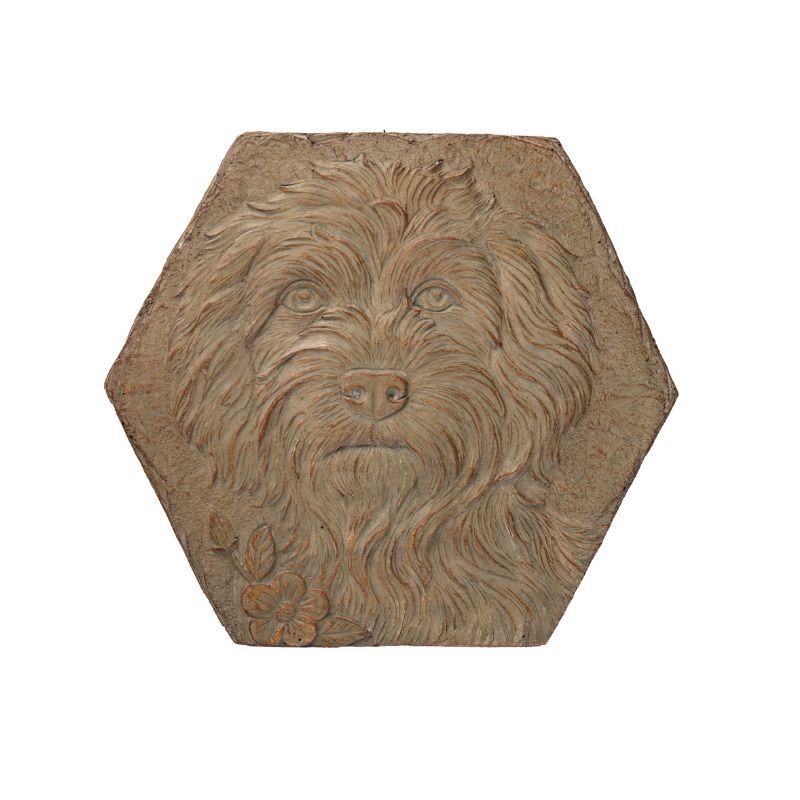 Hexagonal stone stepping stone with a dog portrait in relief.