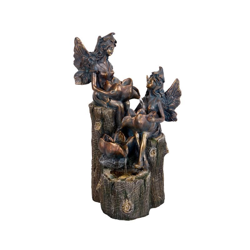 Bronze fairy fountain with two fairies, sitting on a tree trunk, pouring water into a lower bowl.
