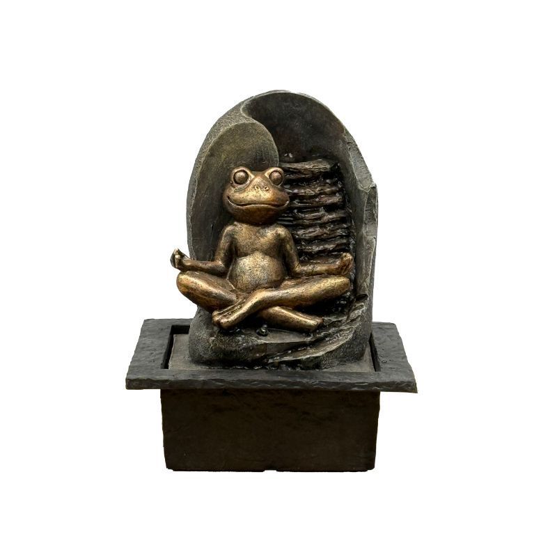 Bronze frog statue in lotus position on a tiered fountain. Water cascades from behind.