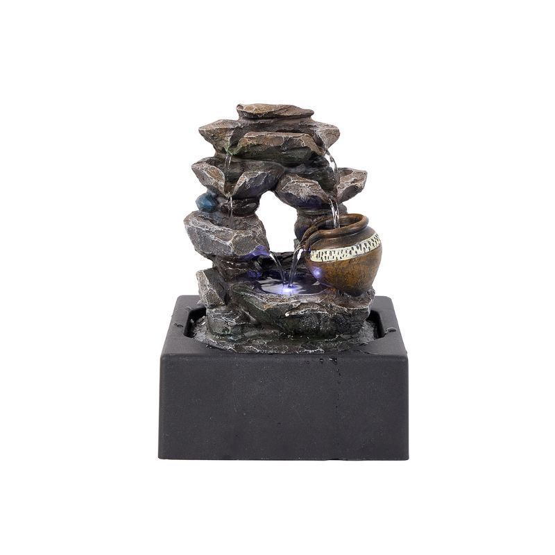 Indoor water fountain with stacked rocks, a pot, and LED lights.