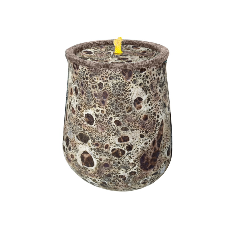 Textured brown candle in a mottled, speckled pattern. Yellow wick on top.