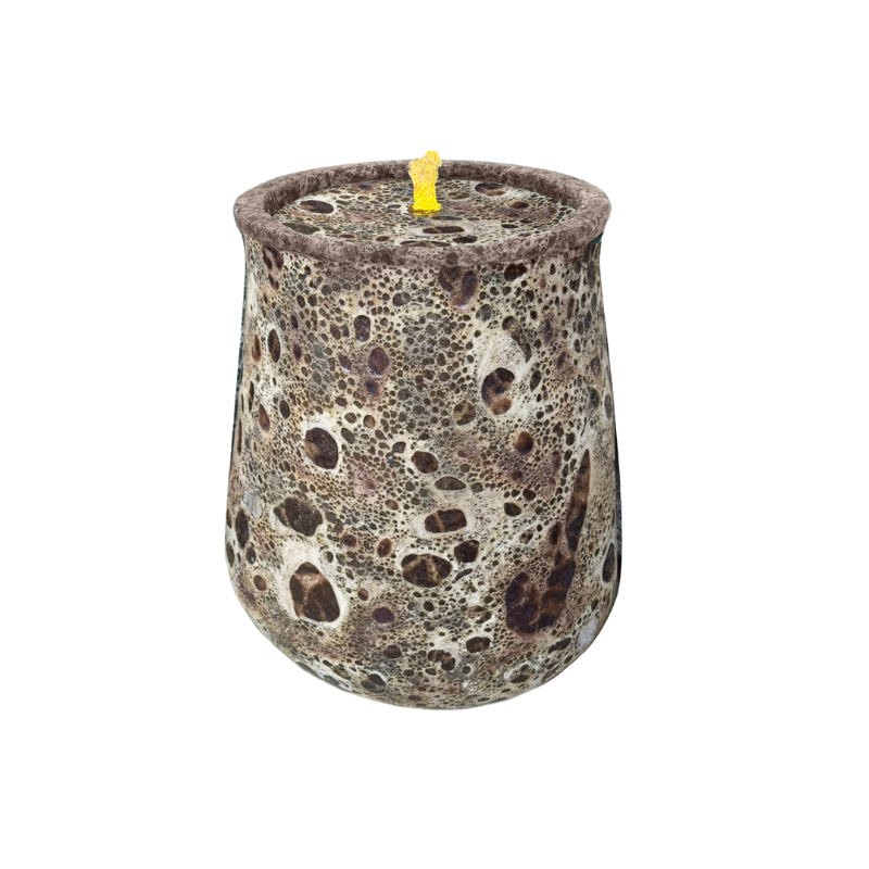 Brown and white speckled candle in a round container with a yellow wick.