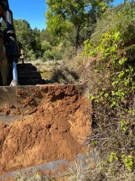 A Bulldozer Is Moving Dirt In A Field — GCE Earthworks Pty Ltd In Krambach, NSW
