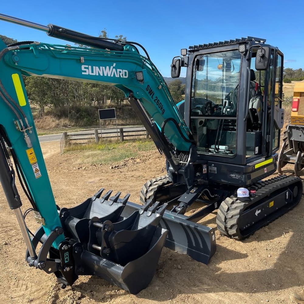 A Green Sunward Excavator Is Parked In A Dirt Field — GCE Earthworks Pty Ltd In Krambach, NSW