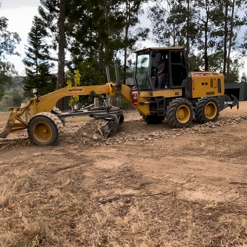 A Yellow Tractor Is Moving Dirt In A Field — GCE Earthworks Pty Ltd In Krambach, NSW