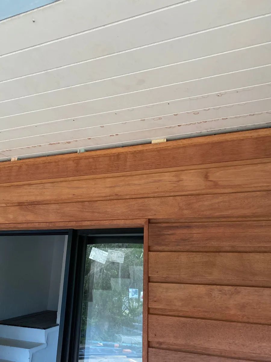 A Wooden Wall With A Window And A White Ceiling — Johnson's Timber Agencies In Ulladulla, NSW