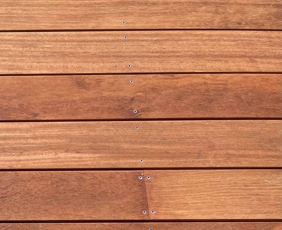 A Close Up Of A Wooden Deck With Screws In It — Johnson's Timber Agencies In Ulladulla, NSW