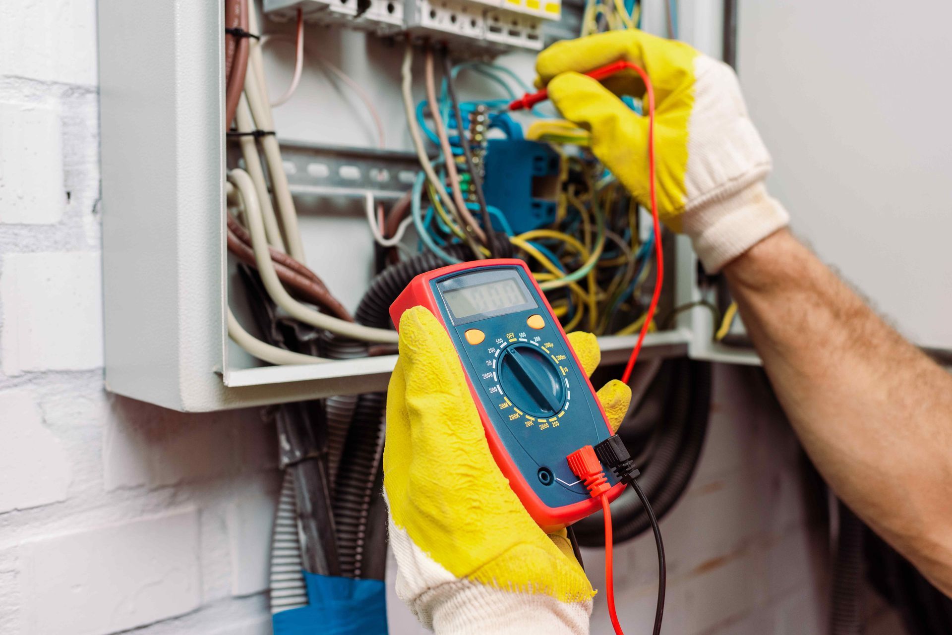 Electrician Using Multimeter to Check Status of Circuit Breaker In Electrical Panel