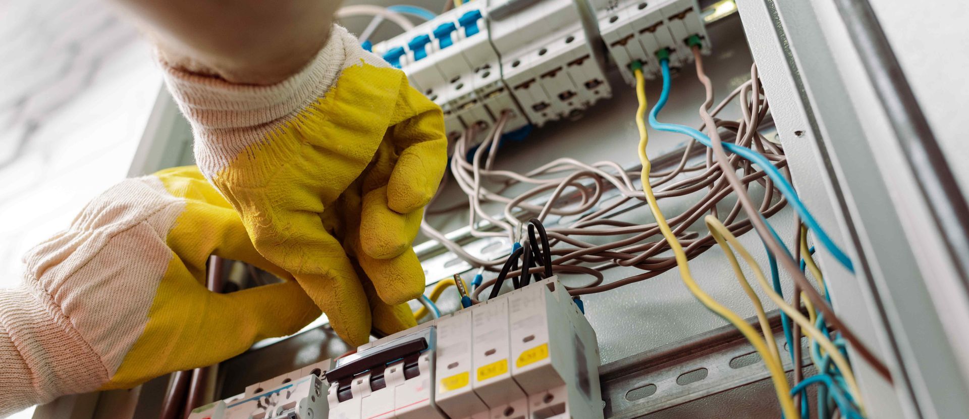 Electrician Fixing Wires In Electrical Panel Box For Safety